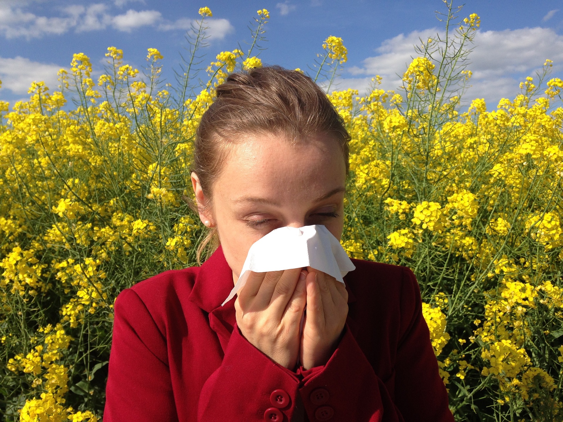 a girl sneezing from spring allergies