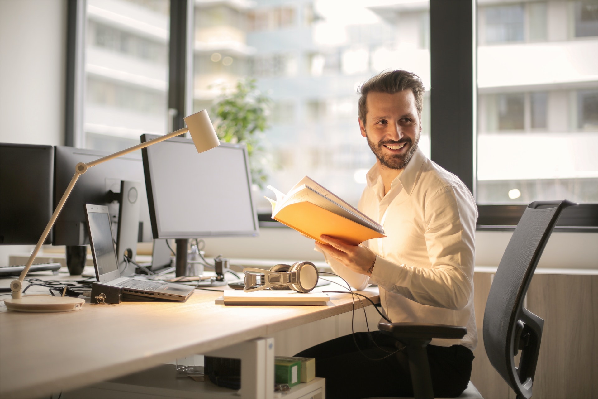 A happy employee at an ergonomically correct desk.